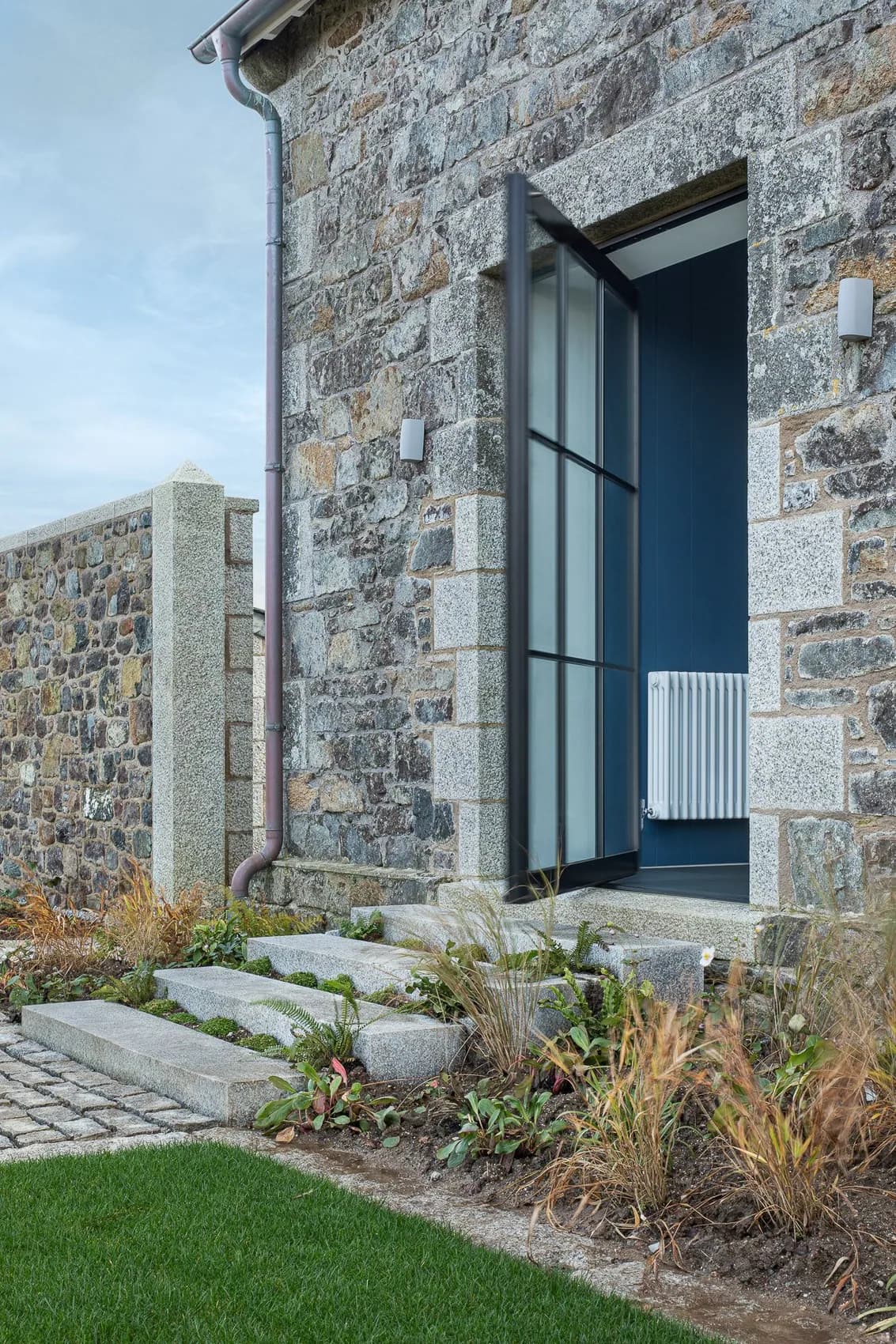 S-Max pivot door set into a stone cottage elevation