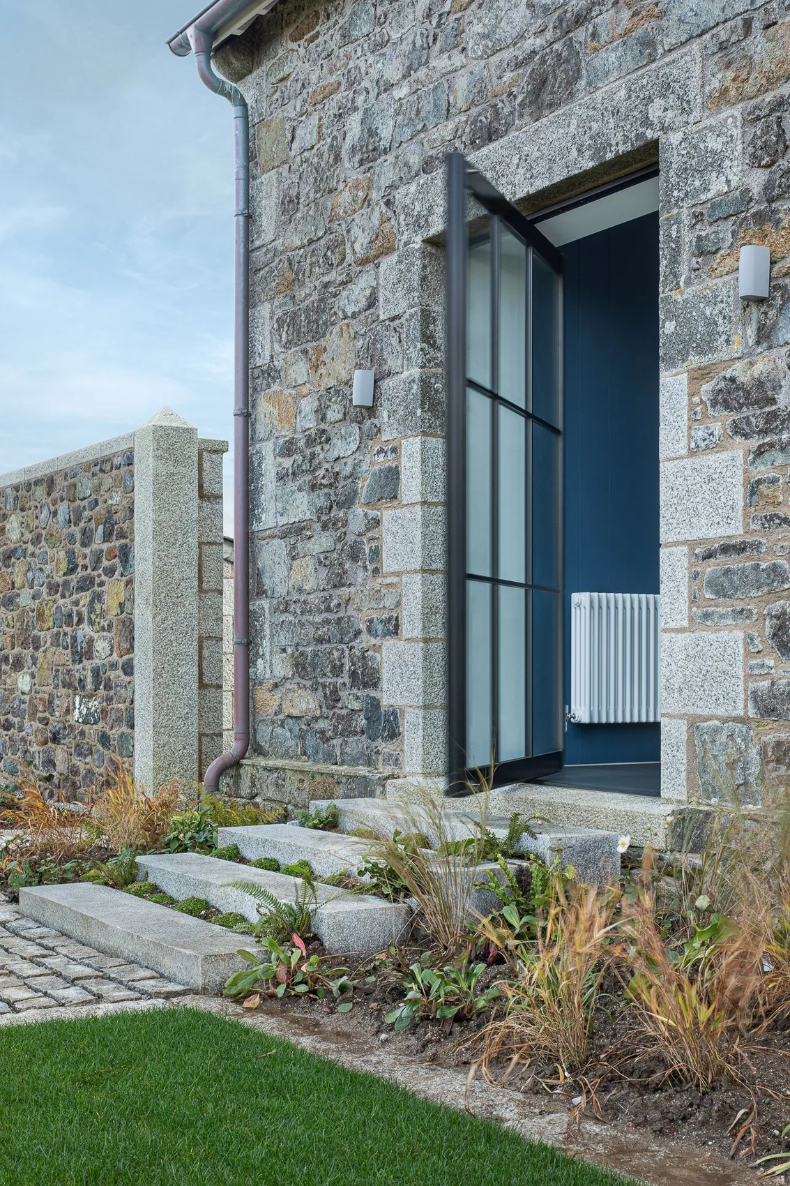 S-Max pivot door set into a stone cottage elevation
