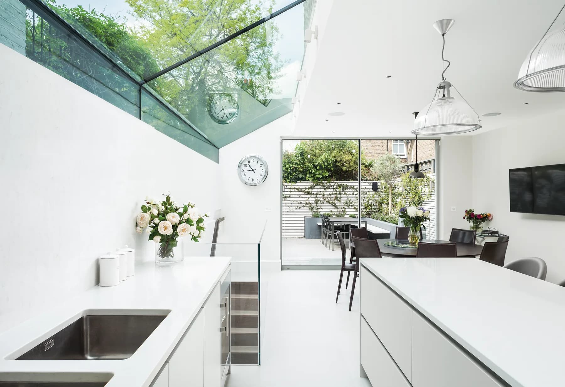 Kitchen island and pendant light below an overhead rooflight