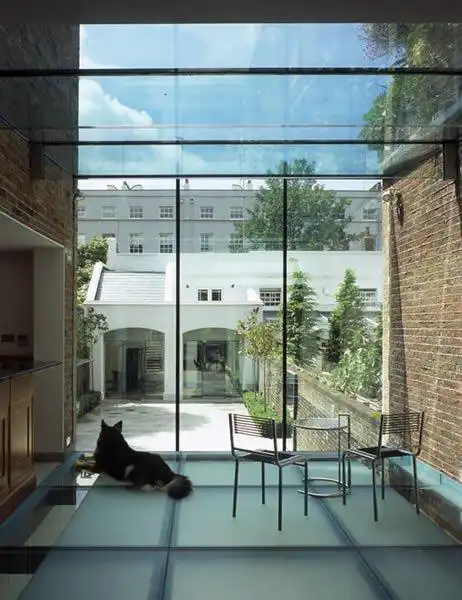 Maxlight aluminium rooflight with exposed steel beams over residential kitchen extension: structural overhead glazing engineered in London