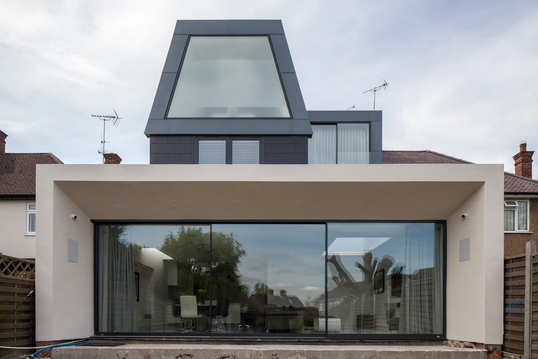 Large fixed window below a glazed gable on a contemporary rear extension