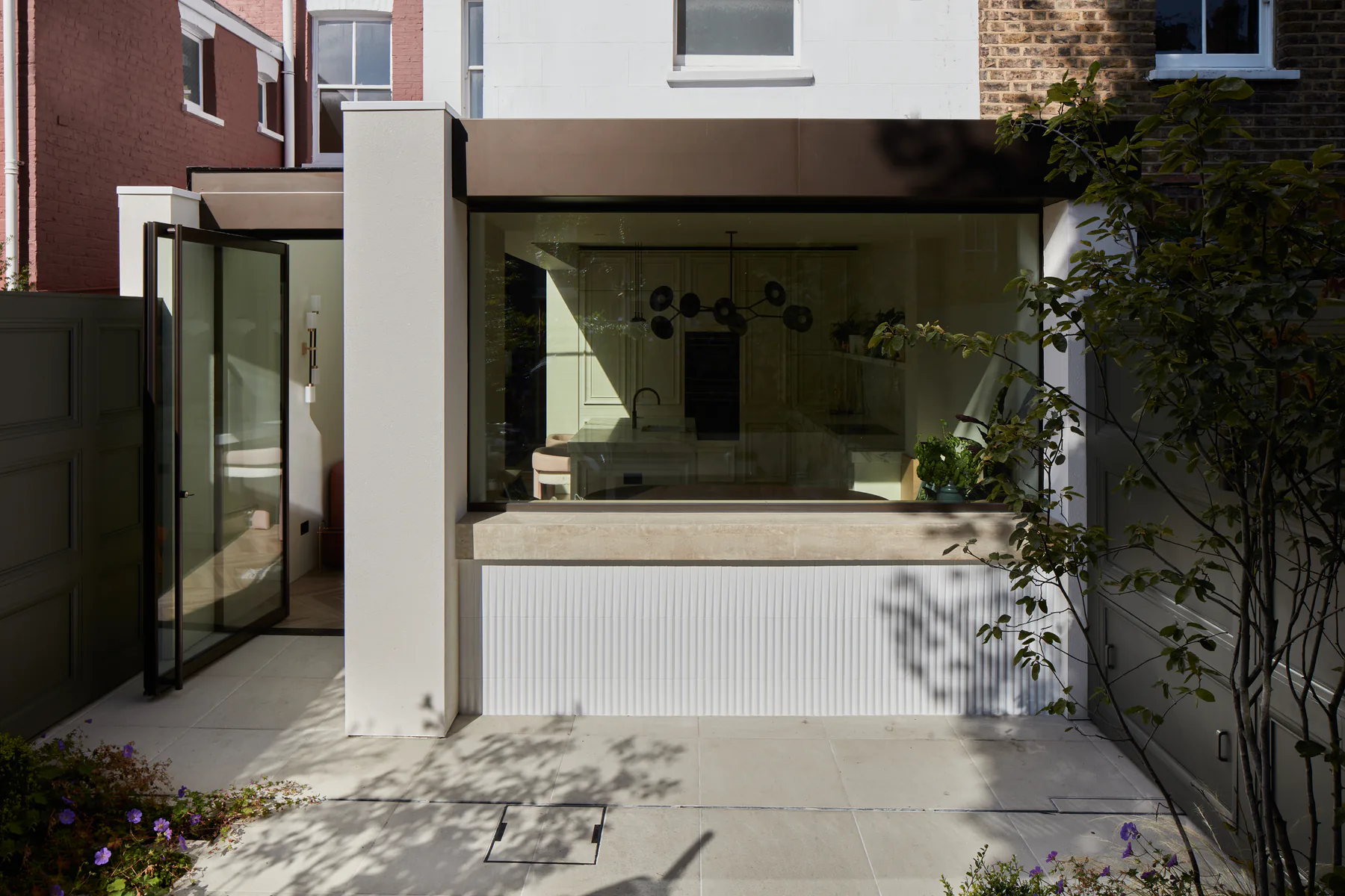 Fixed kitchen window facing a courtyard on a modern white extension