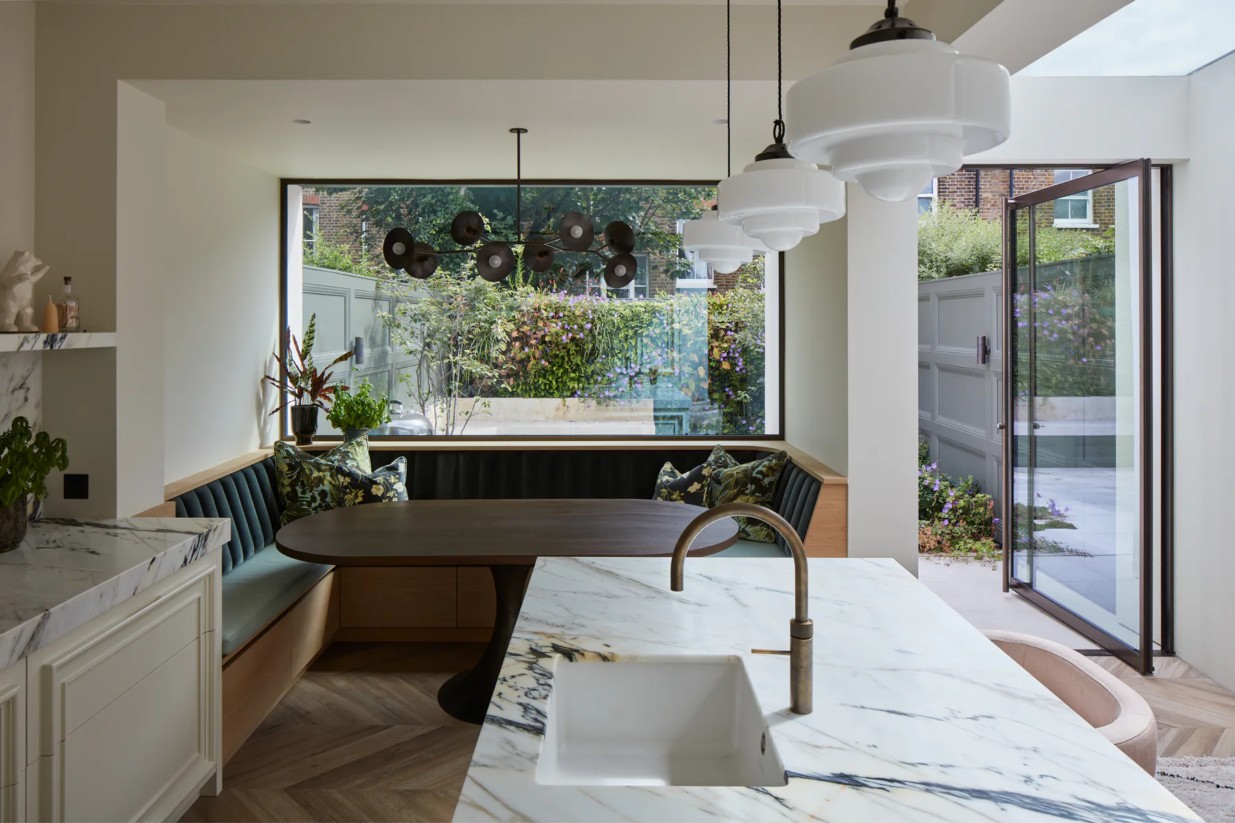 Wide fixed picture window framing planting from a bright kitchen island